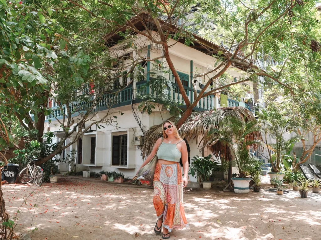 A girl outside the entrance of Waypoint, a top hostel in Arugam Bay