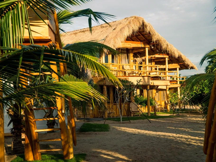 A row of beachfront cabanas at Whiskey Point Resort, one of the best hotels in Arugam Bay