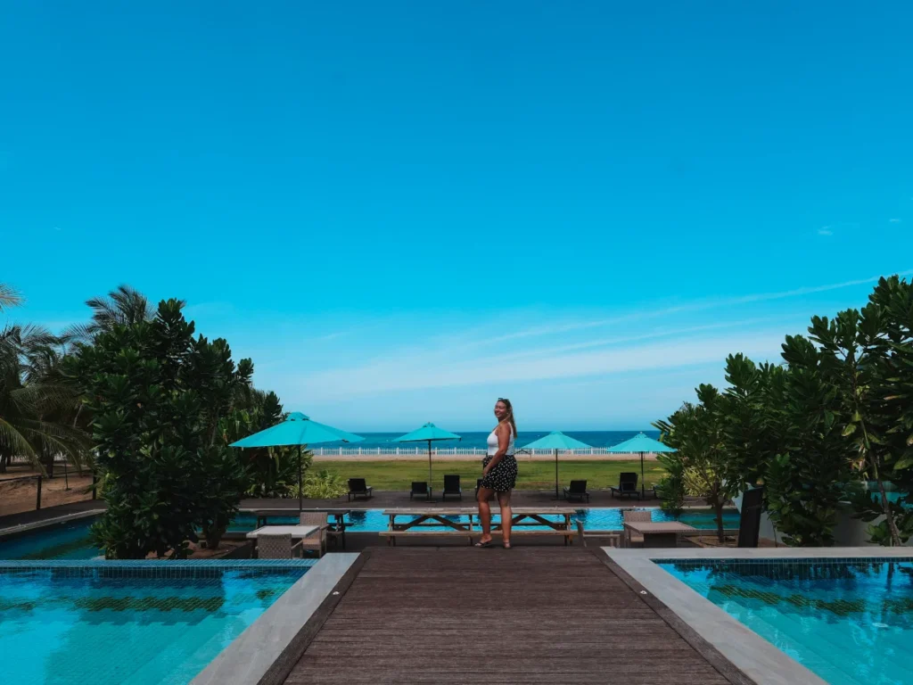 A girl stands between the infinity pools at Aprota Villas