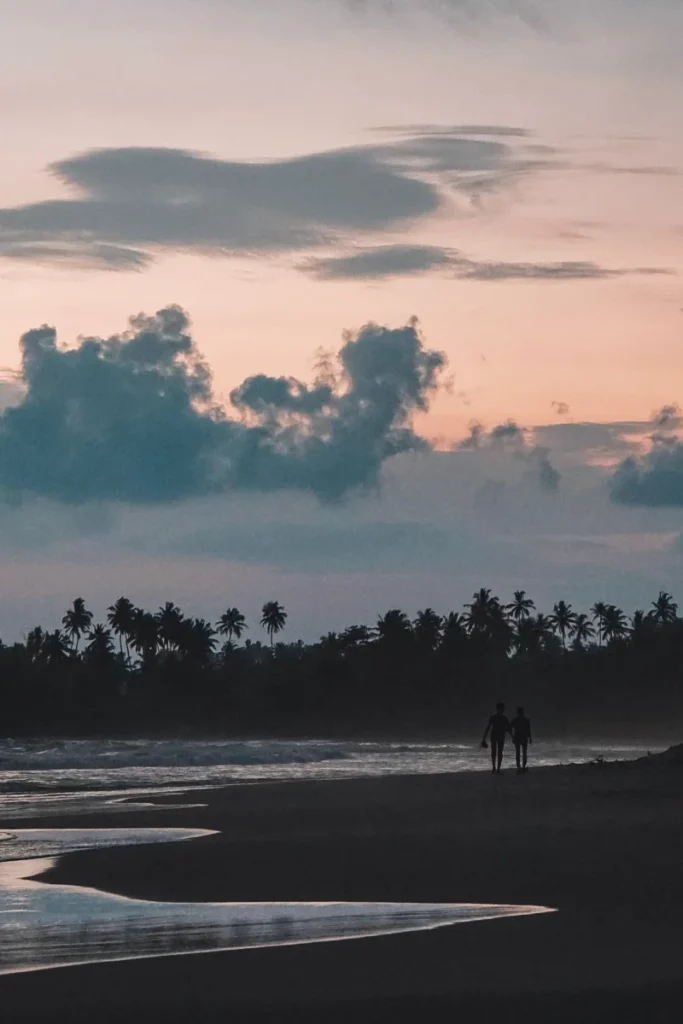 A couple walks down Dickwella beach, one of the best beaches in Hiriketiya