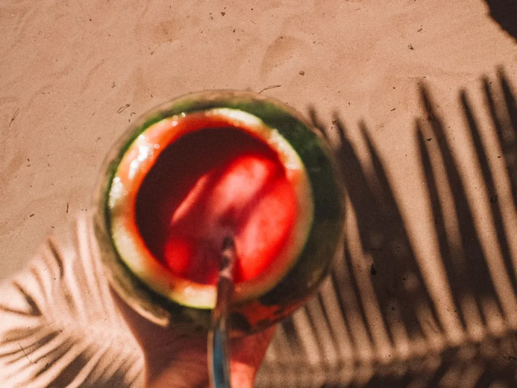 A watermelon juice and palm tree shadow in Ahangama